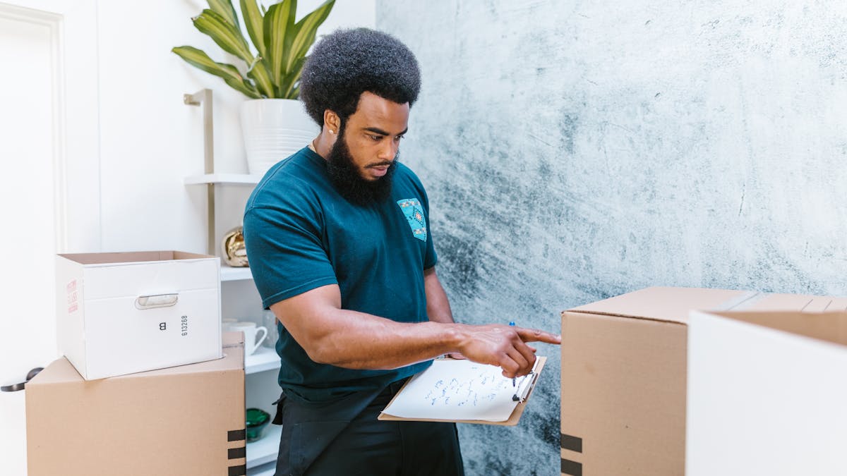 A professional mover focused on organizing boxes.