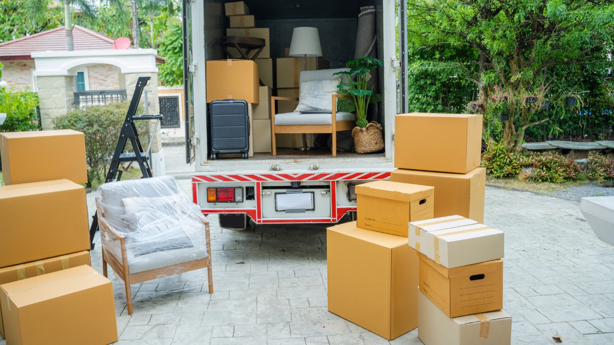 An open moving truck filled with furniture and boxes