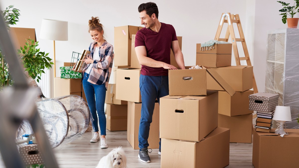 young couple unpacks moving boxes